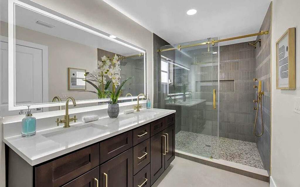 Modern transitional bathroom remodel with gold fixtures and Amalfi gold wall tile in Treasure Island